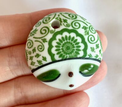 CLOSEUP_Hand Painted Green Doll Face with Floral Folk Art Motif Focal Round Ceramic Pendant